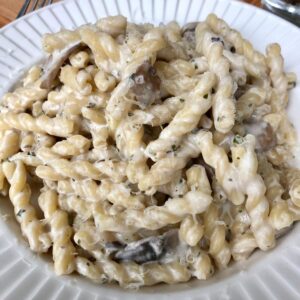 a bowl of creamy cheesy pasta made with boursin and parmesan